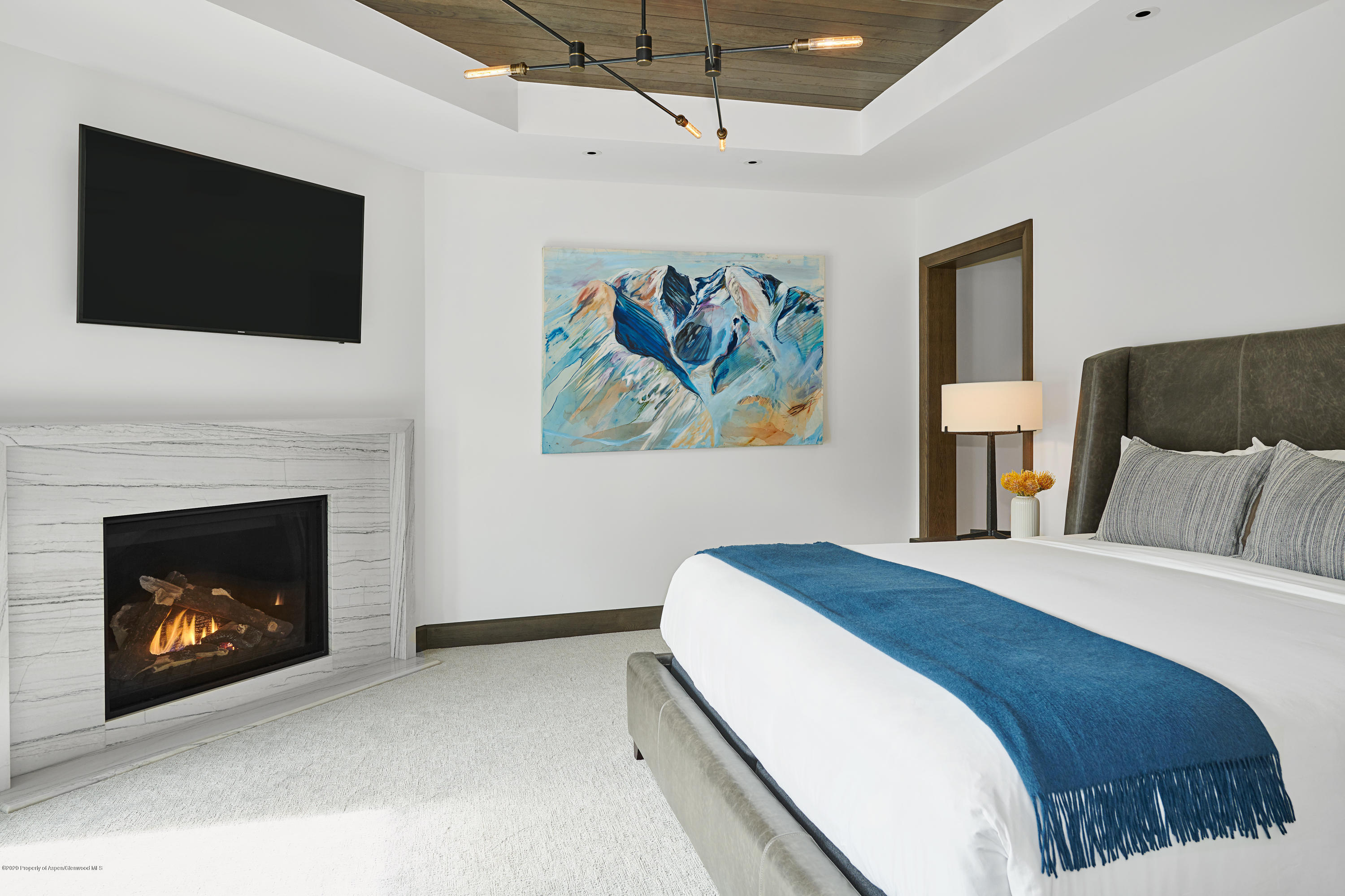 65 Wood Road, Unit 433 Snowmass Village, CO 81615 - Photo 7 of 27 a spacious bedroom with a bed and a fireplace