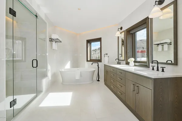 a large bathroom with a double vanity sink toilet mirror and bathtub