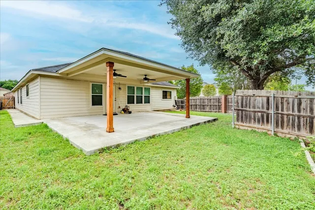 a front view of a house with yard and green space