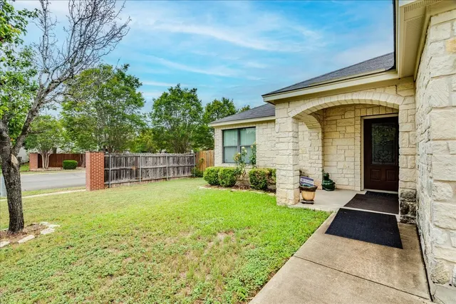 a view of house with backyard space and garden