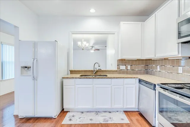 a large kitchen with a sink and cabinets