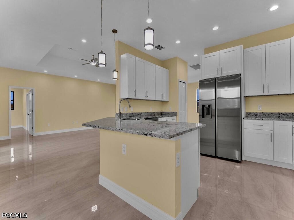 637 Cardinal Street East Lehigh Acres, FL 33974 - Photo 13 of 34 a kitchen with stainless steel appliances granite countertop a refrigerator a sink a stove and a refrigerator