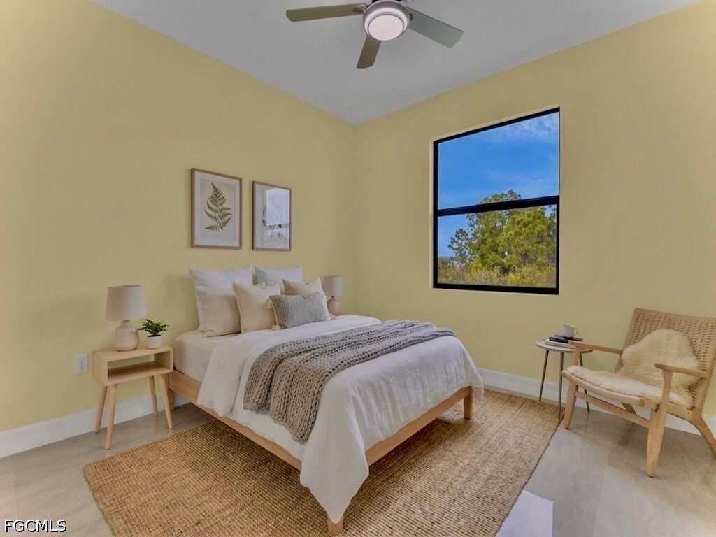 637 Cardinal Street East Lehigh Acres, FL 33974 - Photo 20 of 34 a bedroom with a bed and a chair