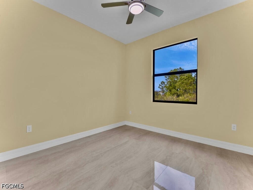 637 Cardinal Street East Lehigh Acres, FL 33974 - Photo 21 of 34 an empty room with a window