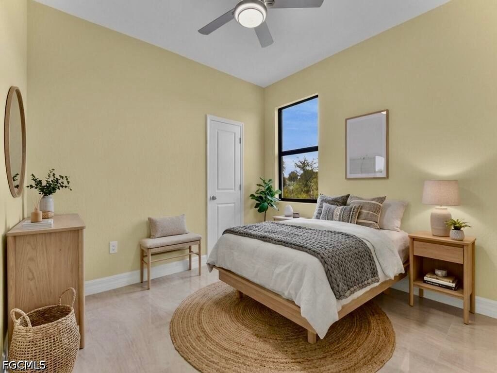 637 Cardinal Street East Lehigh Acres, FL 33974 - Photo 22 of 34 a bedroom with a bed a chair and potted plant