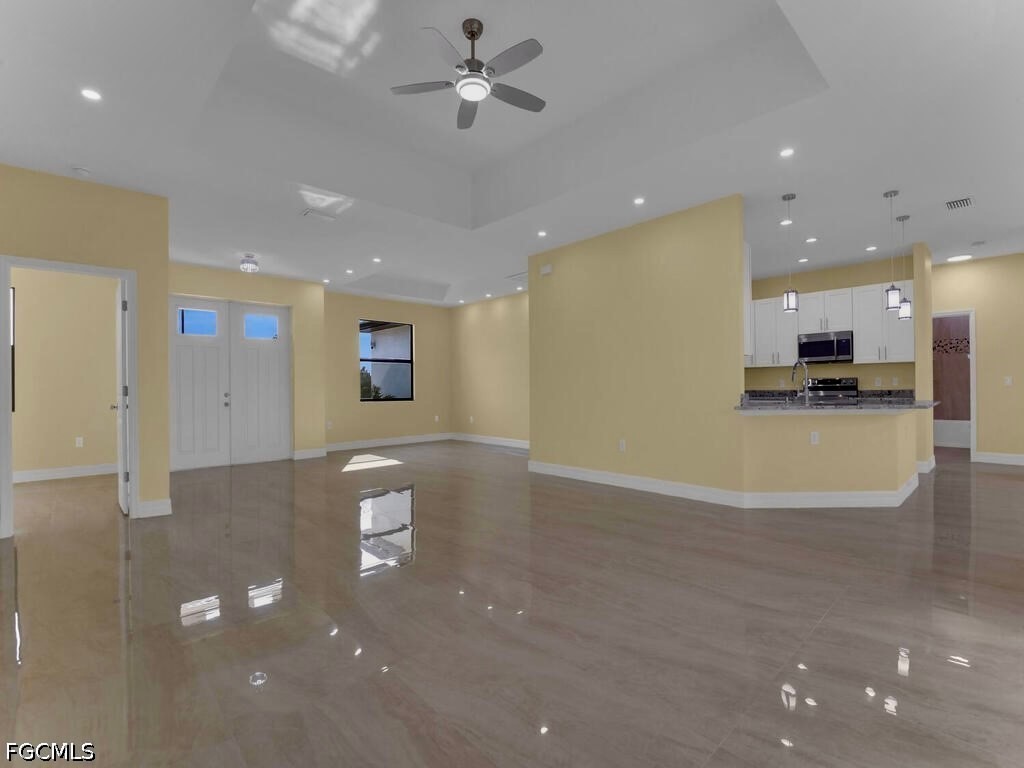 637 Cardinal Street East Lehigh Acres, FL 33974 - Photo 28 of 34 a view of a kitchen with a sink and a microwave