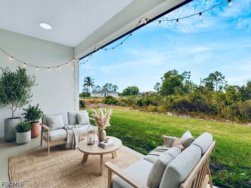 637 Cardinal Street East Lehigh Acres, FL 33974 - Photo 30 of 34 a view of a patio with couches chairs and a yard