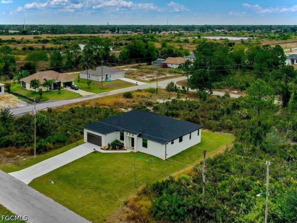 637 Cardinal Street East Lehigh Acres, FL 33974 - Photo 32 of 34 a view of a house with a yard