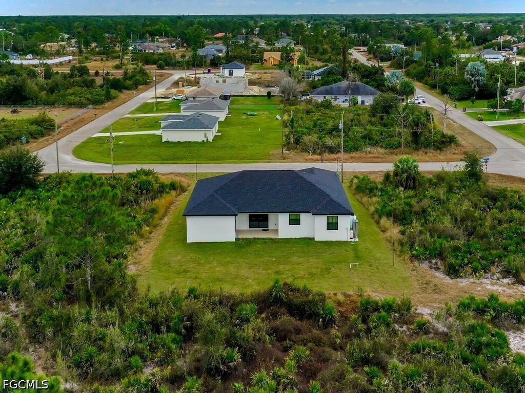 637 Cardinal Street East Lehigh Acres, FL 33974 - Photo 33 of 34 an aerial view of a house with a yard and lake view