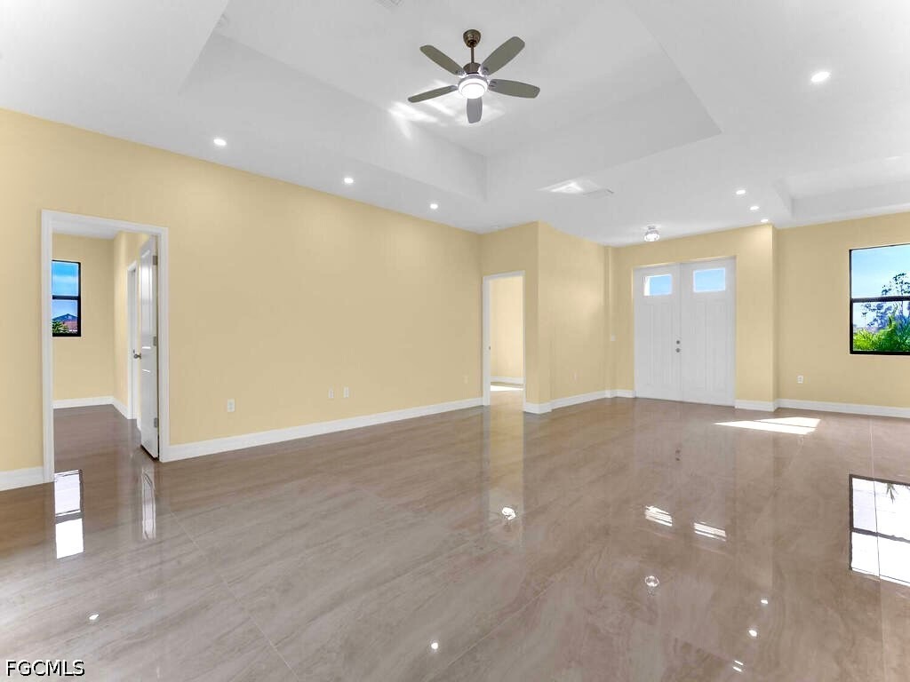 637 Cardinal Street East Lehigh Acres, FL 33974 - Photo 6 of 34 a view of an empty room with window and wooden floor