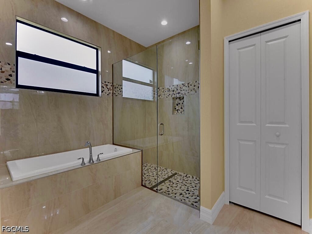 637 Cardinal Street East Lehigh Acres, FL 33974 - Photo 9 of 34 a bathroom with a bathtub and shower