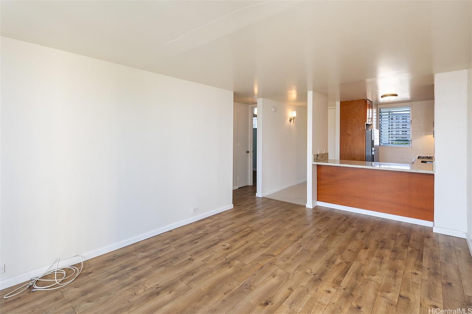 949 Ala Nanala Street, Unit 501 Honolulu, HI 96818 - Photo 4 of 18 a view of a kitchen with wooden floor