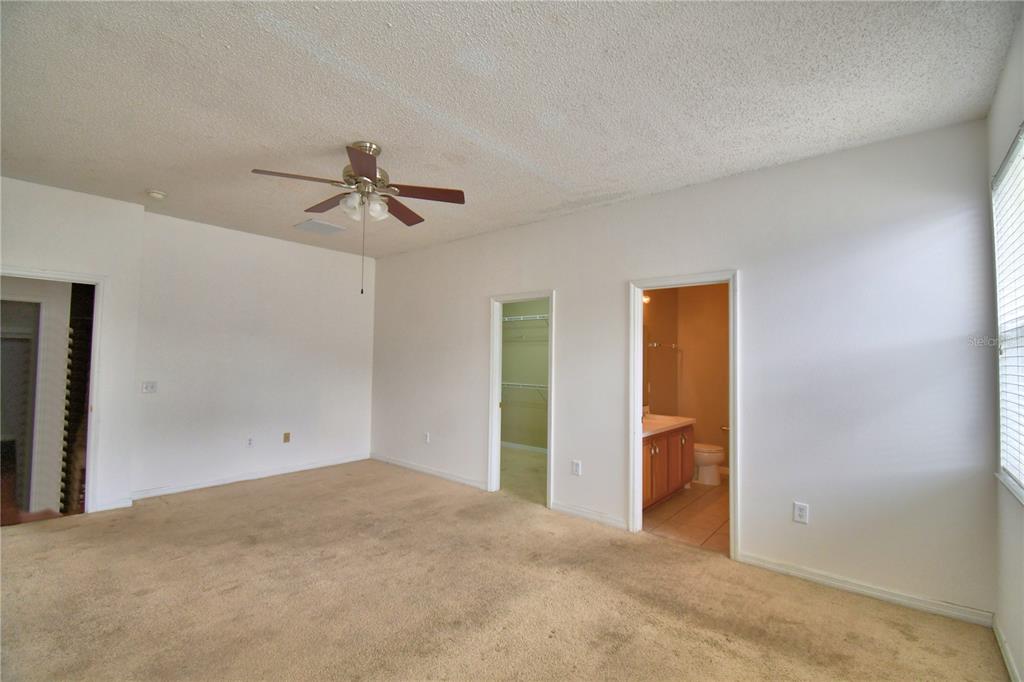 154 Canna Drive Davenport, FL 33897 - Photo 19 of 85 a view of a room with a ceiling fan and closet area