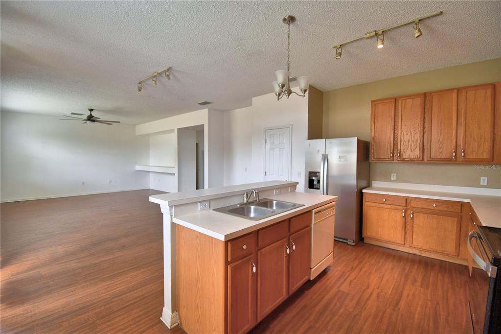 154 Canna Drive Davenport, FL 33897 - Photo 28 of 85 a kitchen with stainless steel appliances granite countertop a sink a stove and a refrigerator