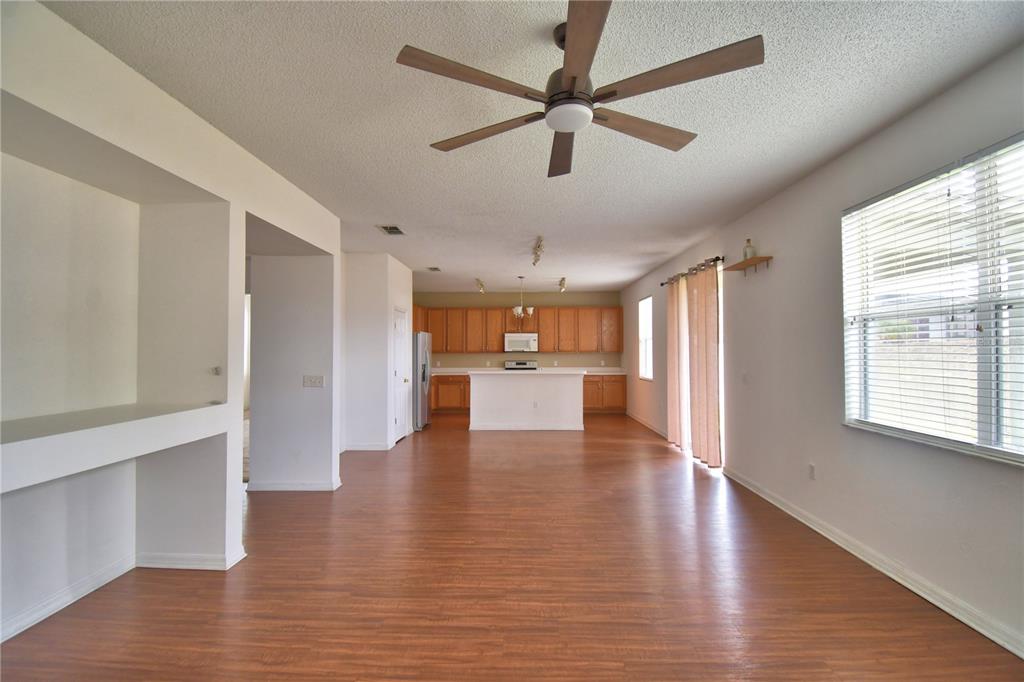 154 Canna Drive Davenport, FL 33897 - Photo 34 of 85 a view of an empty room with wooden floor and a window