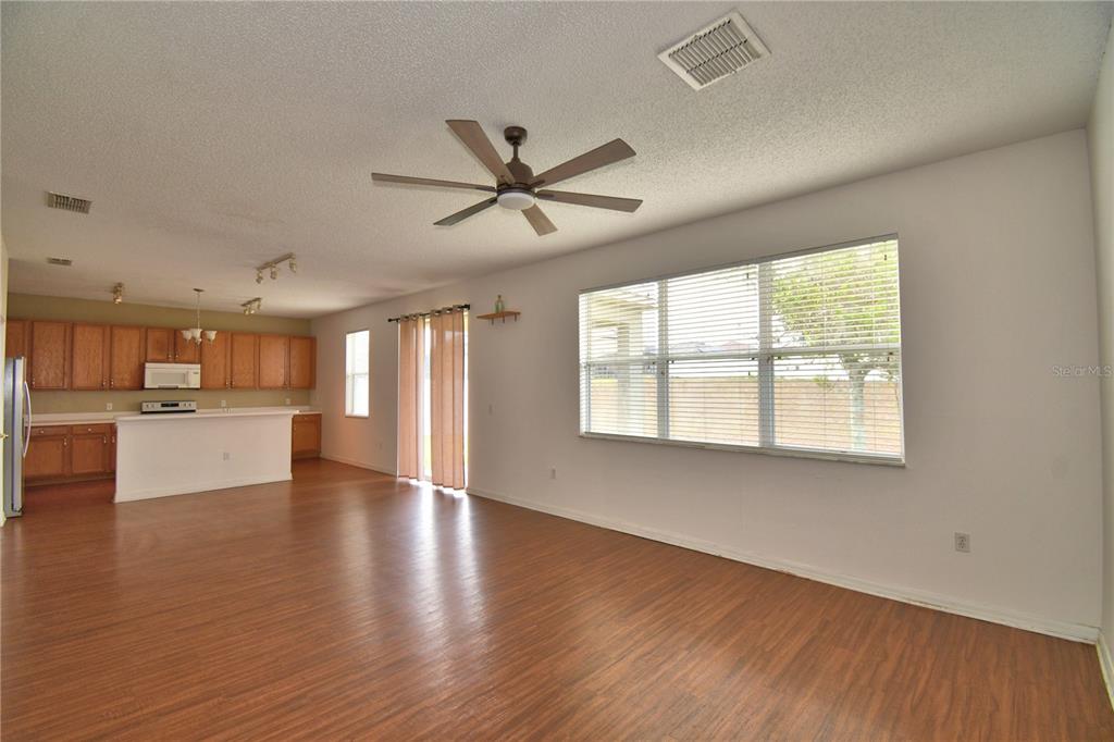 154 Canna Drive Davenport, FL 33897 - Photo 38 of 85 a view of an empty room with a window and wooden floor