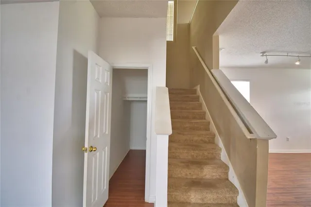 an empty room with closet and wooden floor