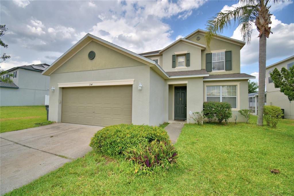 154 Canna Drive Davenport, FL 33897 - Photo 4 of 85 front view of a house with a yard