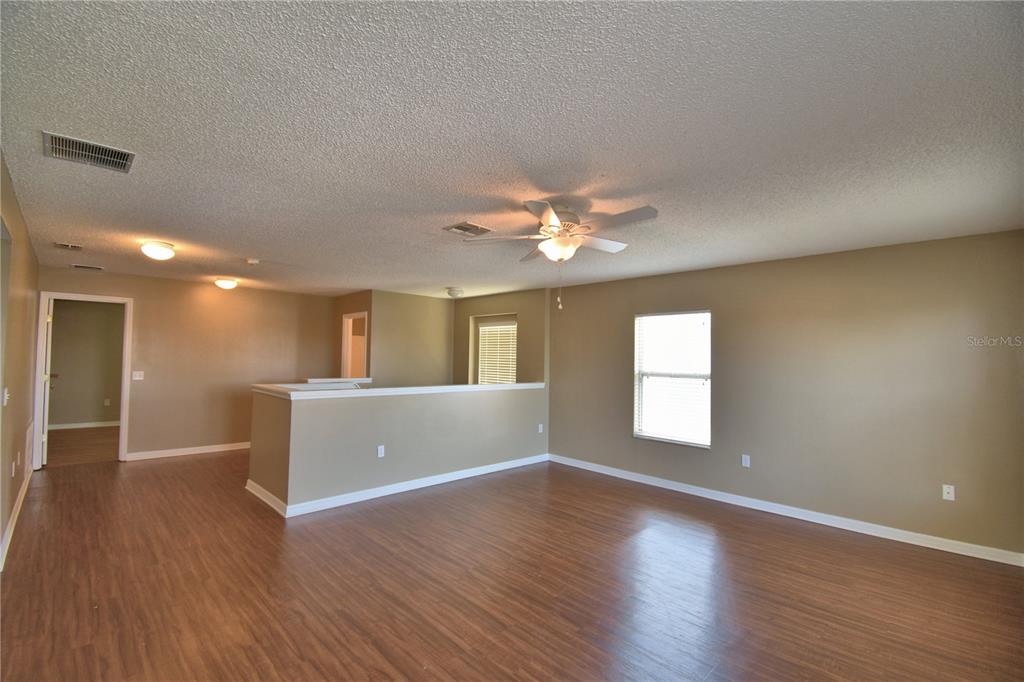 154 Canna Drive Davenport, FL 33897 - Photo 45 of 85 a view of livingroom and hall with wooden floor