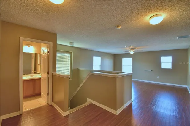 a view of a house with backyard and a tree