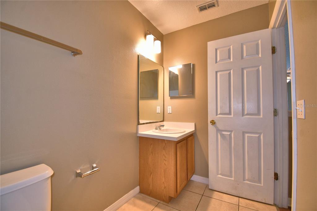 154 Canna Drive Davenport, FL 33897 - Photo 50 of 85 a bathroom with a sink a toilet and shower