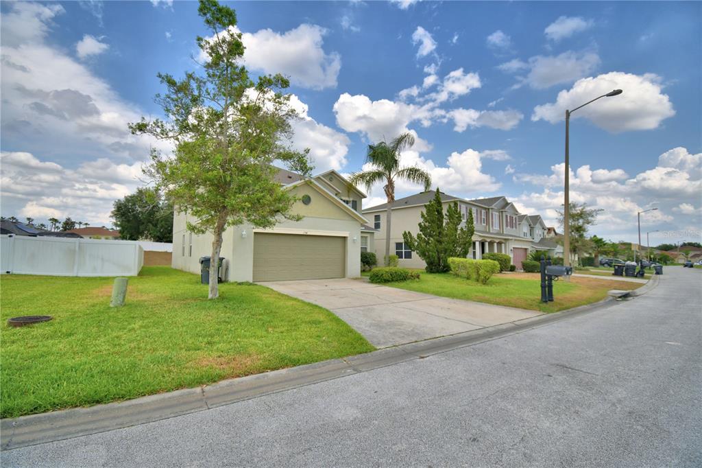 154 Canna Drive Davenport, FL 33897 - Photo 5 of 85 a view of a house with a backyard and a tree
