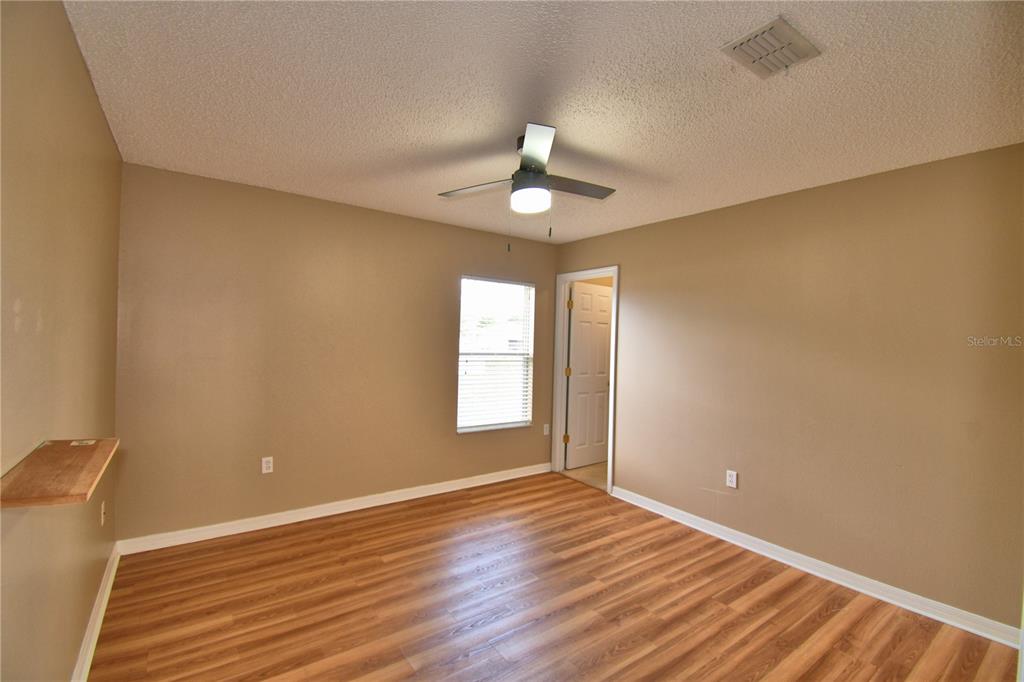 154 Canna Drive Davenport, FL 33897 - Photo 54 of 85 a view of an empty room with window and wooden floor