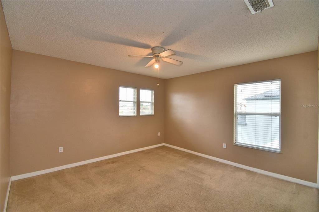 154 Canna Drive Davenport, FL 33897 - Photo 57 of 85 an empty room with windows and fan