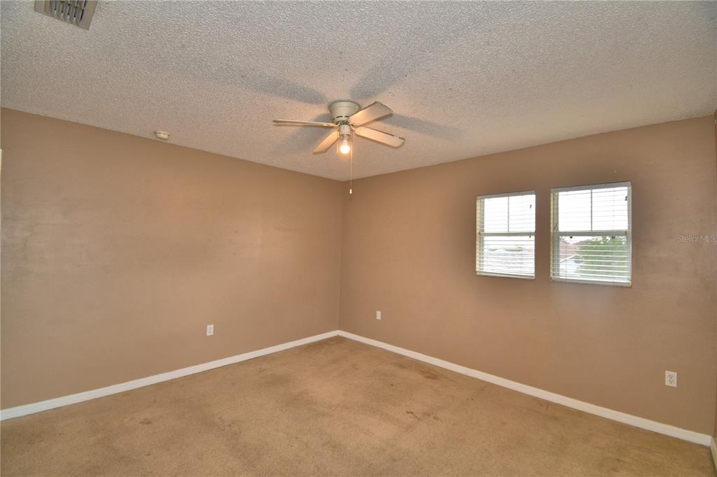 154 Canna Drive Davenport, FL 33897 - Photo 59 of 85 an empty room with a window and a ceiling fan