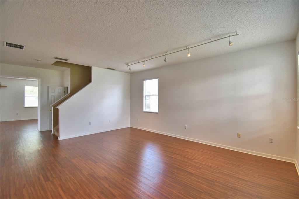 154 Canna Drive Davenport, FL 33897 - Photo 6 of 85 a view of an empty room with wooden floor and a window