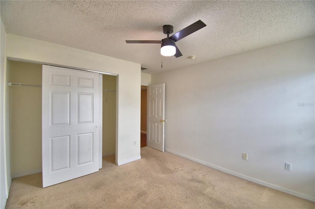 154 Canna Drive Davenport, FL 33897 - Photo 62 of 85 an empty room with closet and wooden floor