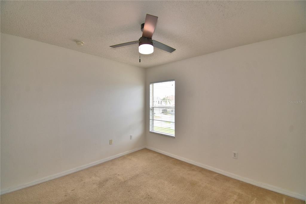 154 Canna Drive Davenport, FL 33897 - Photo 65 of 85 wooden floor in an empty room with a window