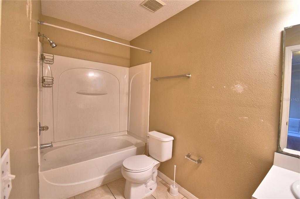 154 Canna Drive Davenport, FL 33897 - Photo 67 of 85 a bathroom with a shower and a toilet