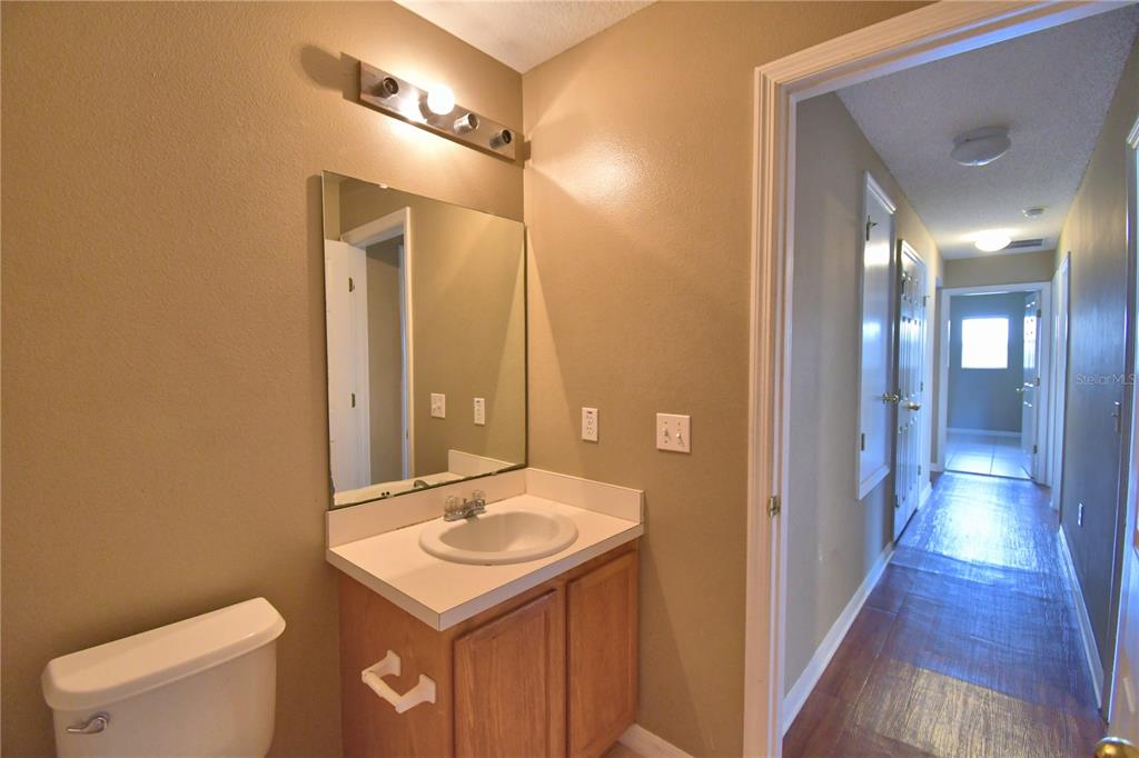 154 Canna Drive Davenport, FL 33897 - Photo 68 of 85 a bathroom with a sink a toilet and shower a mirror