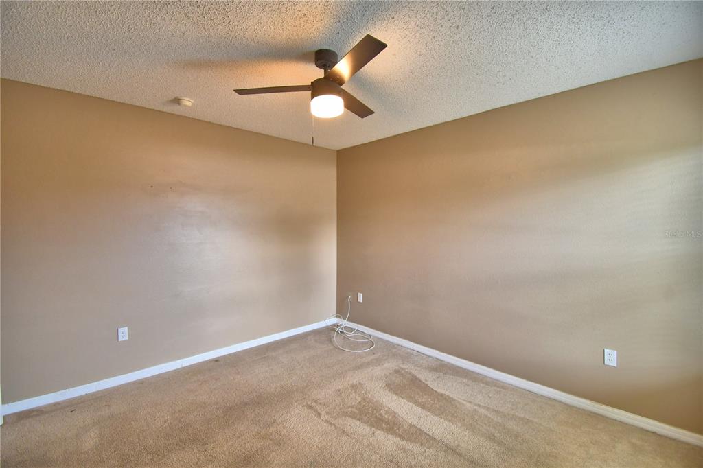 154 Canna Drive Davenport, FL 33897 - Photo 71 of 85 an empty room with a ceiling fan and a window