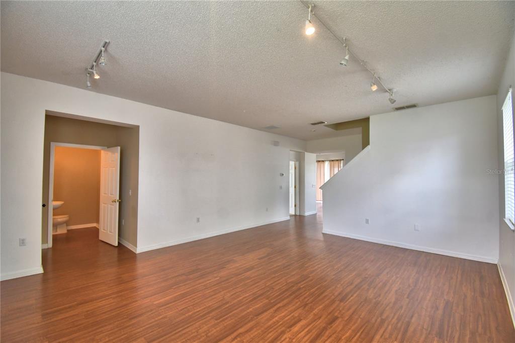 154 Canna Drive Davenport, FL 33897 - Photo 8 of 85 wooden floor in an empty room with a window