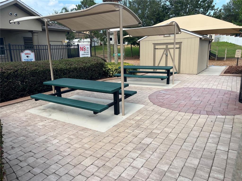 154 Canna Drive Davenport, FL 33897 - Photo 85 of 85 a view of a patio with a table and chairs under an umbrella