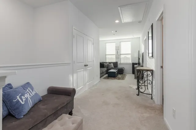 a spacious bedroom with a bed and wooden floor