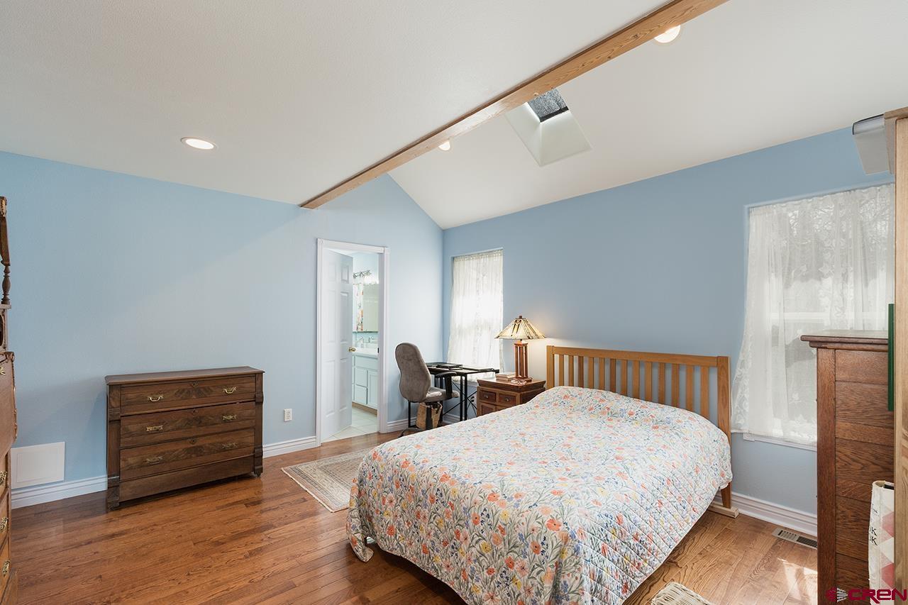 221 Jenkins Ranch Road, Unit H Durango, CO 81301 - Photo 13 of 26 a bedroom with a bed and wooden floor