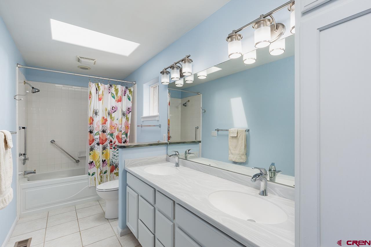 221 Jenkins Ranch Road, Unit H Durango, CO 81301 - Photo 14 of 26 a bathroom with a tub sink and mirror