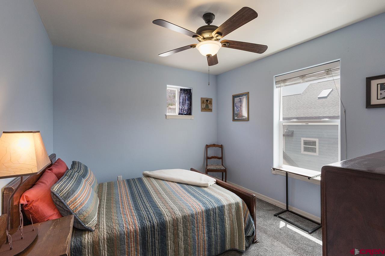 221 Jenkins Ranch Road, Unit H Durango, CO 81301 - Photo 17 of 26 a bedroom with a bed and a window