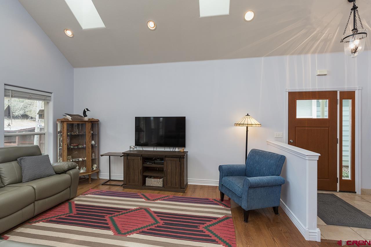 221 Jenkins Ranch Road, Unit H Durango, CO 81301 - Photo 6 of 26 a living room with furniture and a flat screen tv