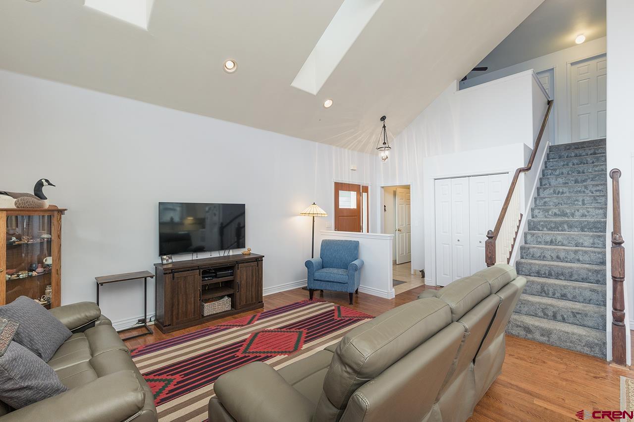 221 Jenkins Ranch Road, Unit H Durango, CO 81301 - Photo 7 of 26 a living room with furniture a flat screen tv and a fireplace