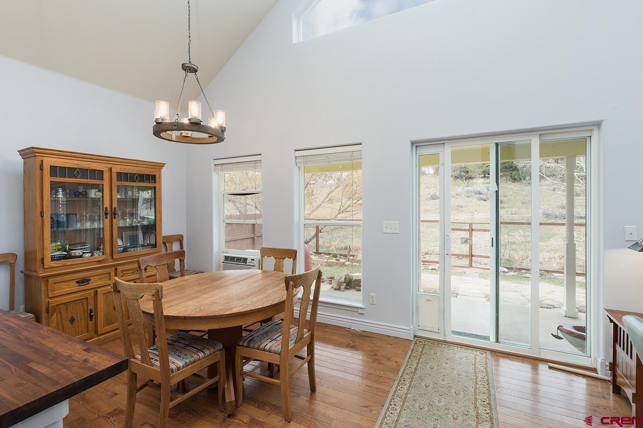 221 Jenkins Ranch Road, Unit H Durango, CO 81301 - Photo 8 of 26 a view of a dining room with furniture window and wooden floor