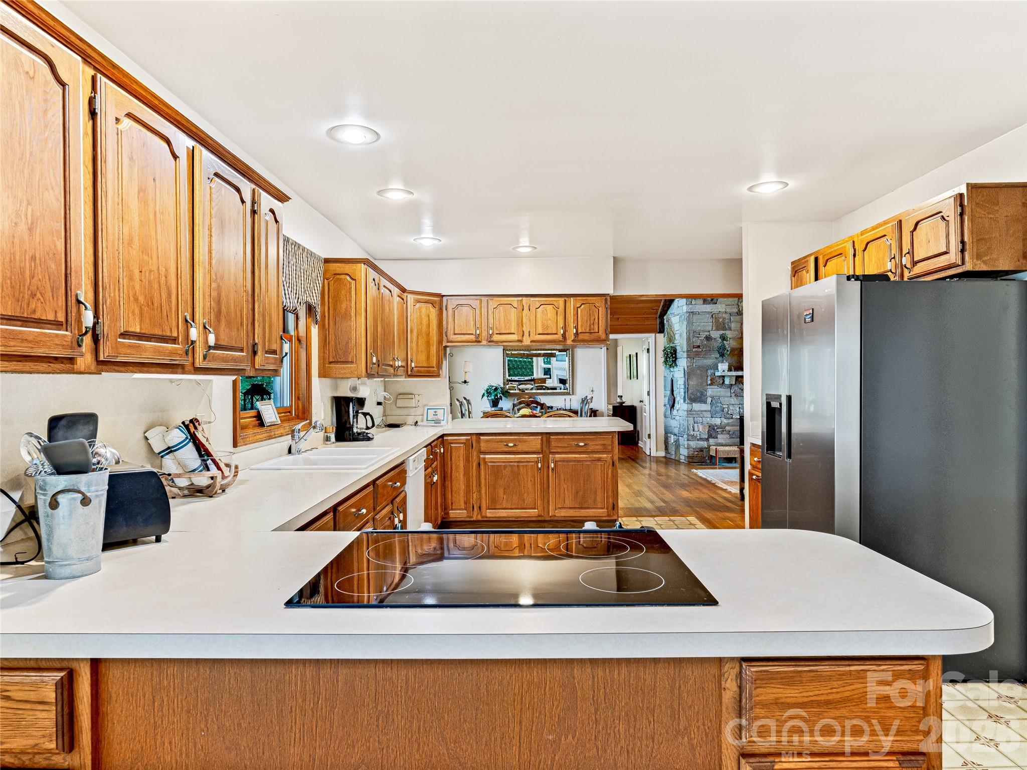 796 Hawk Mountain Road, Unit 36R Lake Toxaway, NC 28747 - Photo 14 of 39 a kitchen that has a lot of cabinets in it and wooden floors