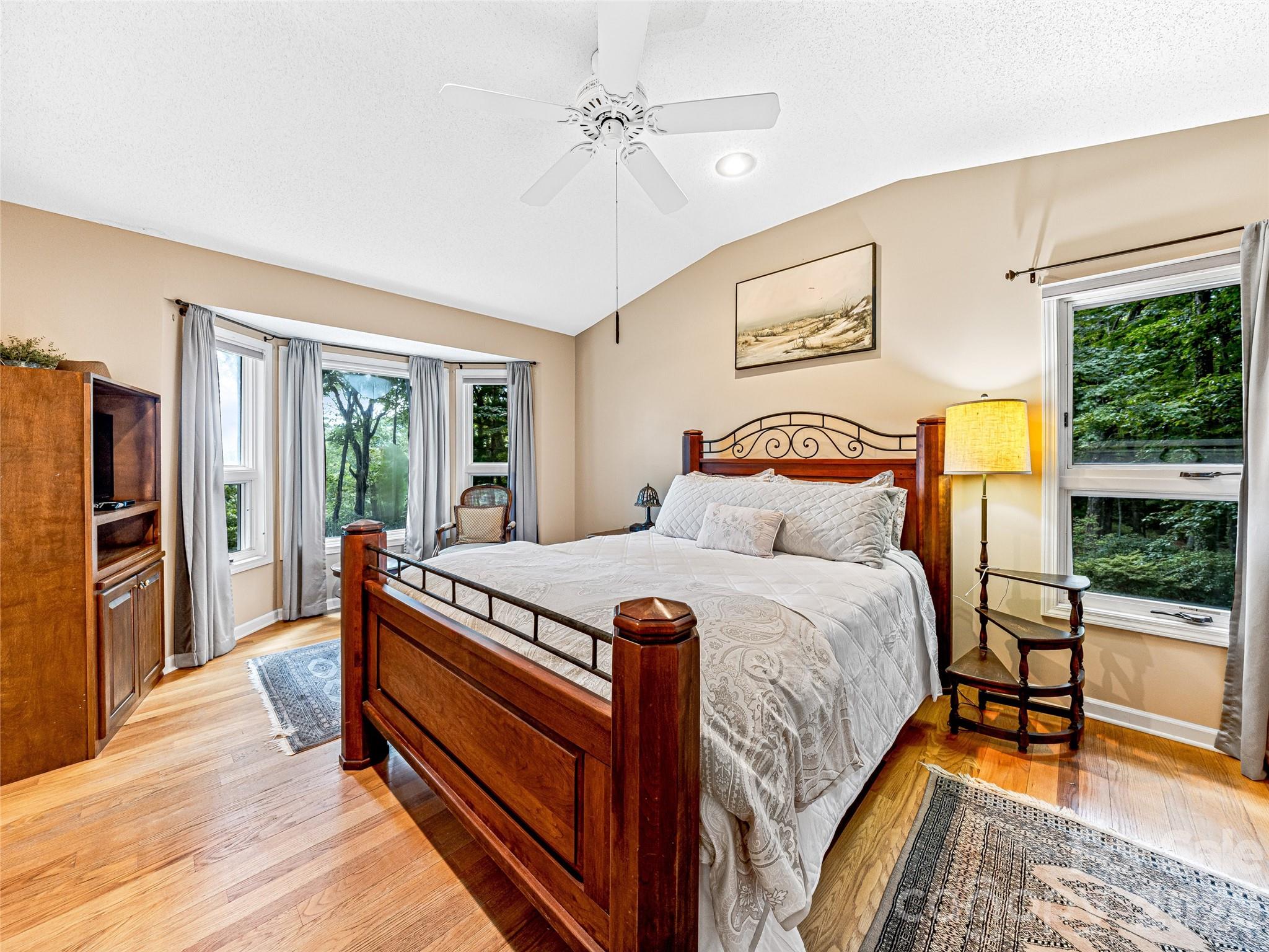 796 Hawk Mountain Road, Unit 36R Lake Toxaway, NC 28747 - Photo 21 of 39 a bedroom with a bed and wooden floor