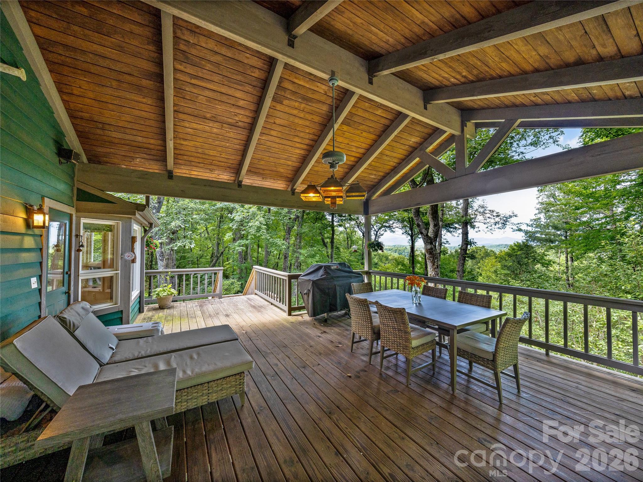 796 Hawk Mountain Road, Unit 36R Lake Toxaway, NC 28747 - Photo 29 of 39 a view of a patio with a table and chairs under an umbrella