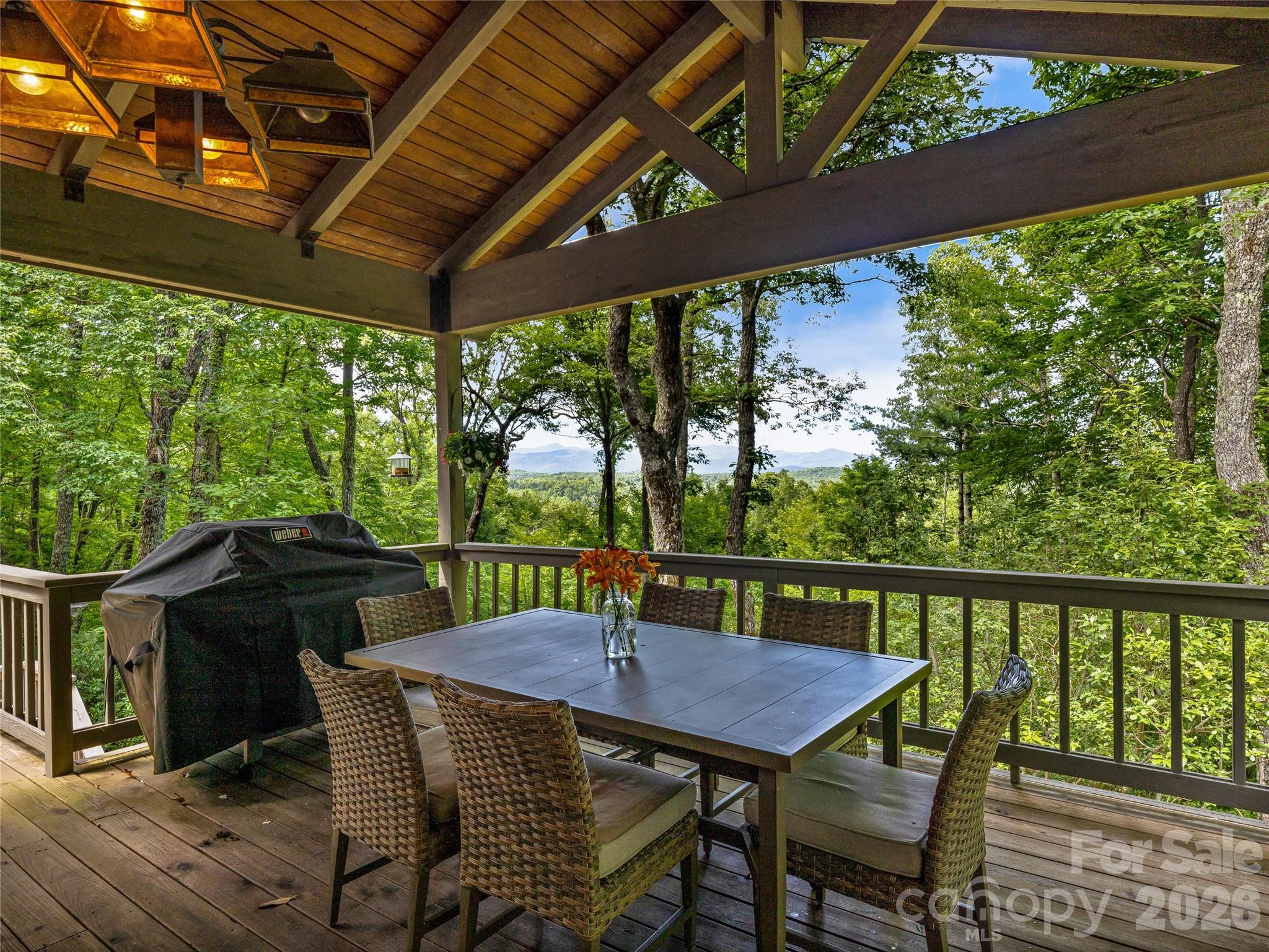 796 Hawk Mountain Road, Unit 36R Lake Toxaway, NC 28747 - Photo 30 of 39 a view of a patio with a table chairs and a backyard