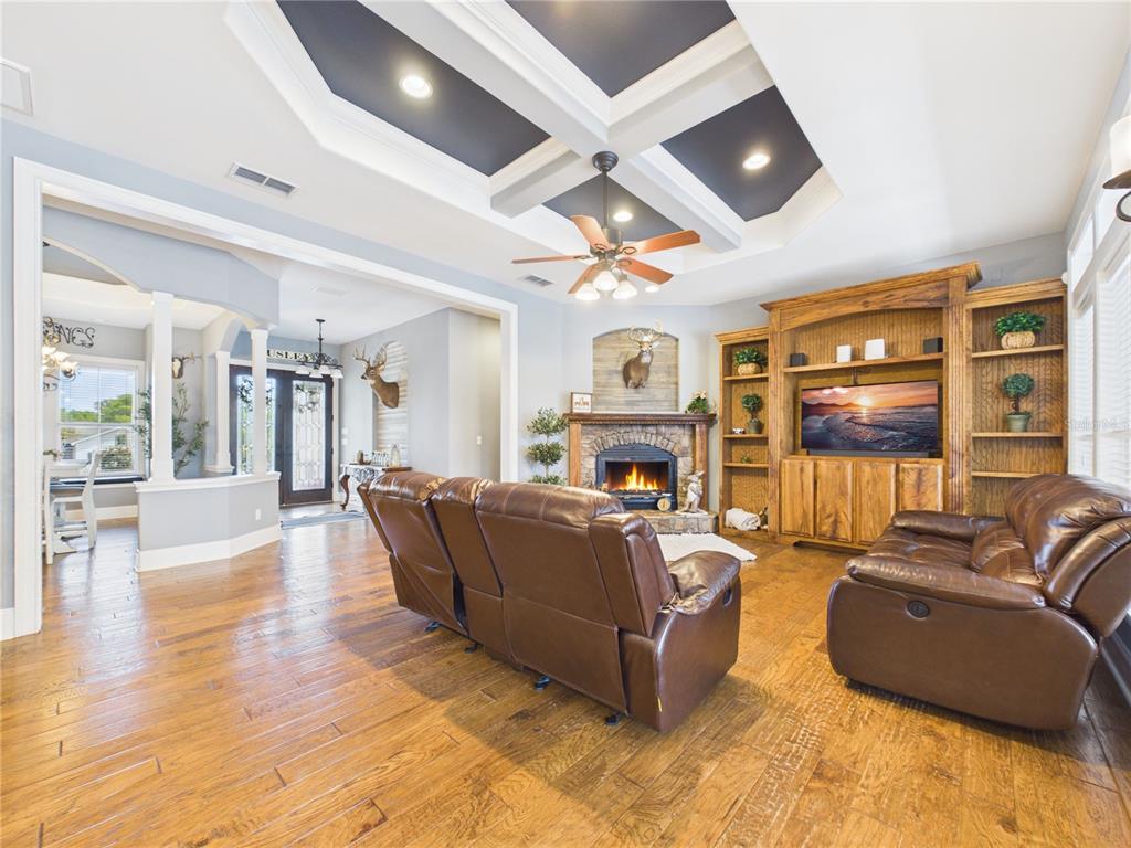 2215 Southwest 80th Street Ocala, FL 34476 - Photo 12 of 64 a living room with furniture a fireplace and a flat screen tv