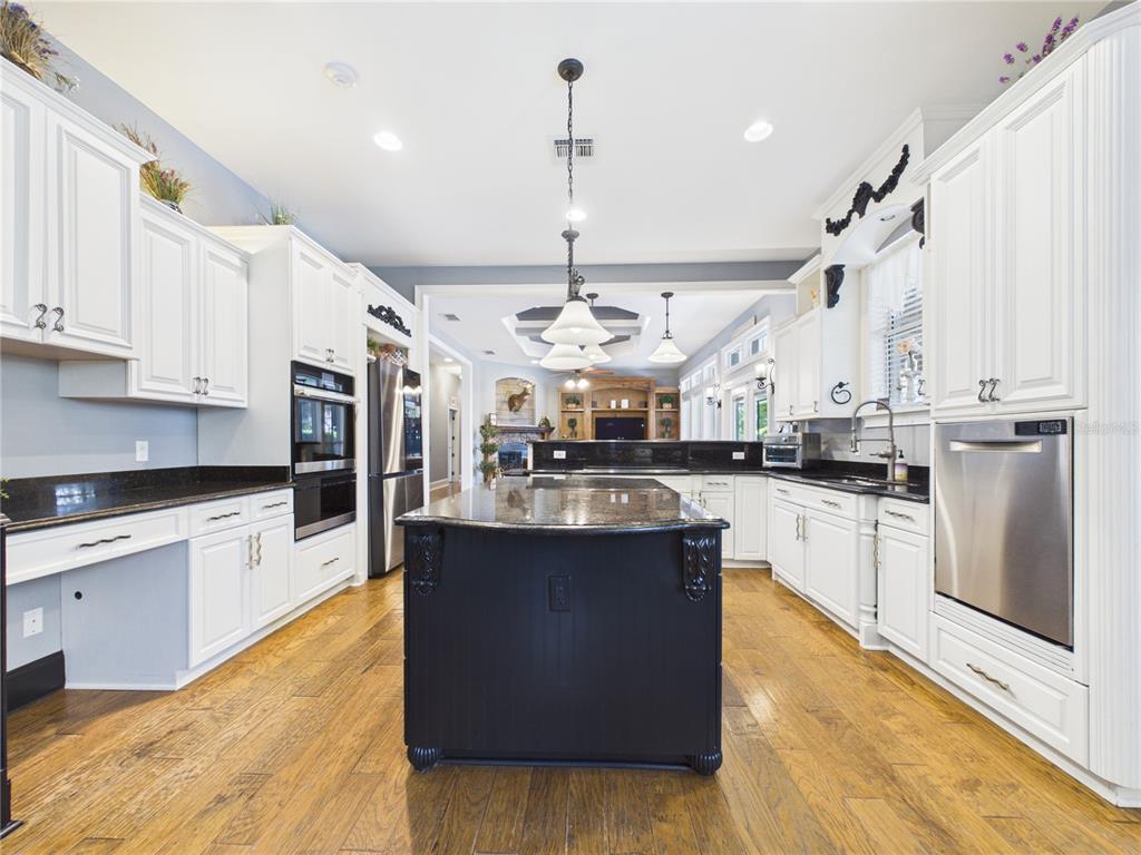 2215 Southwest 80th Street Ocala, FL 34476 - Photo 13 of 64 a large kitchen with stainless steel appliances granite countertop a stove and cabinets